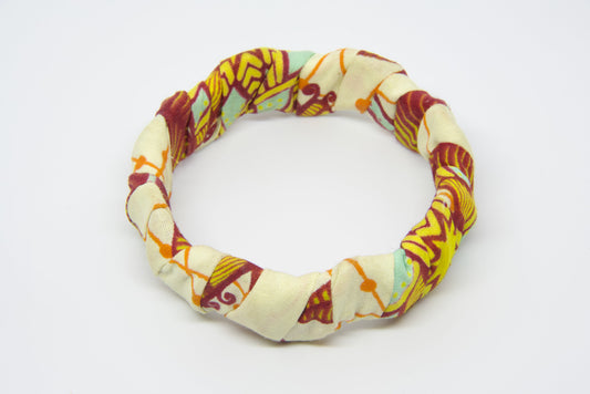 Bracelet torsadé rigide wax beige motifs bordeaux, jaune et orange artisanal - Djêkoo Wax