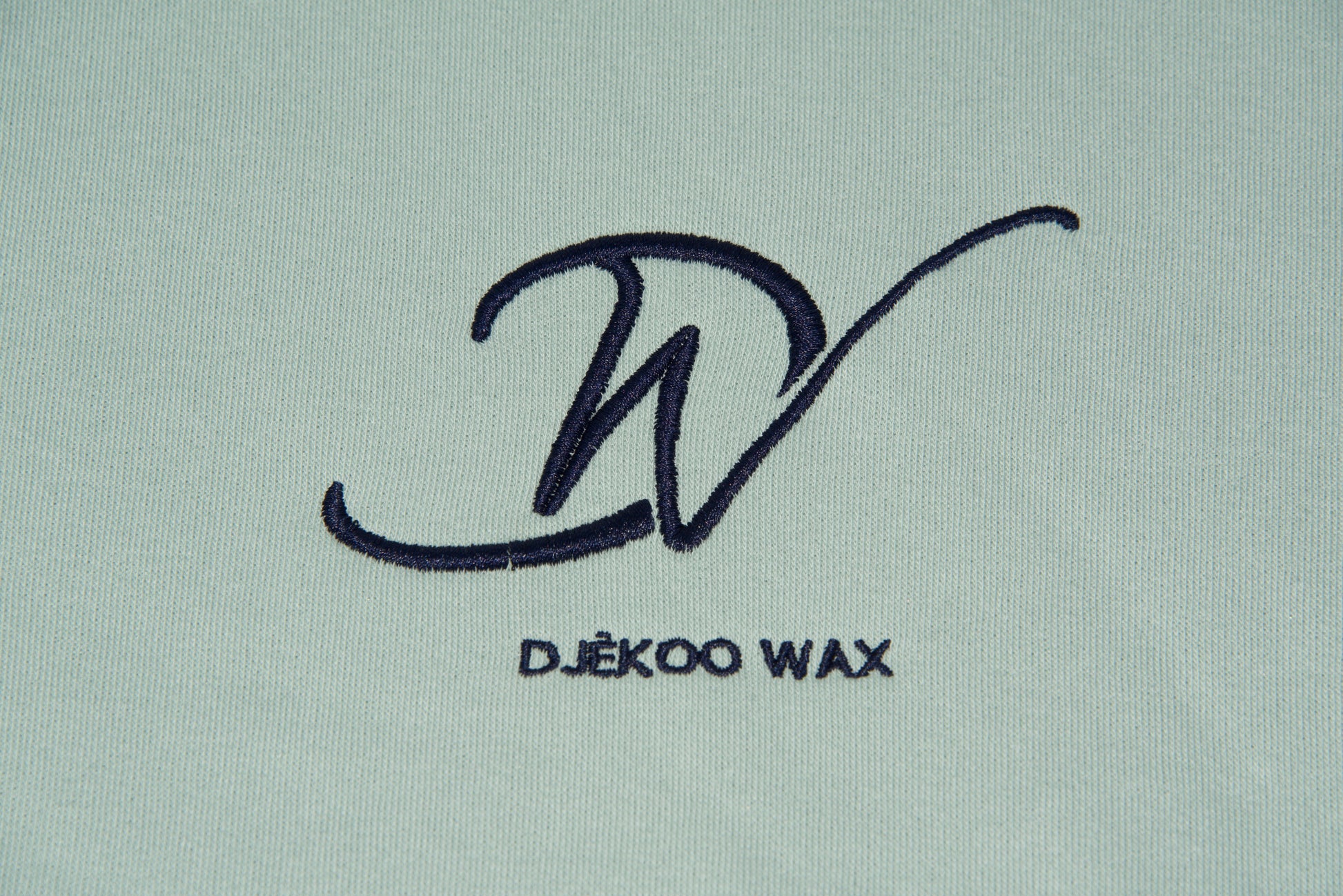 Broderie 10cm x 10cm bleu foncé du Logo Djêkoo Wax sur le devant du sweat à capuche