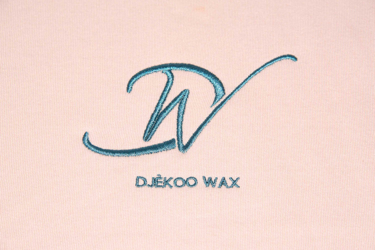 Détail de la broderie verte Djêkoo Wax sur sweat à capuche bio femme rose en wax véritable